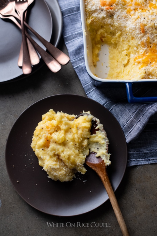 Three Cheese Mashed Potato Casserole Bake on a plate with spoon