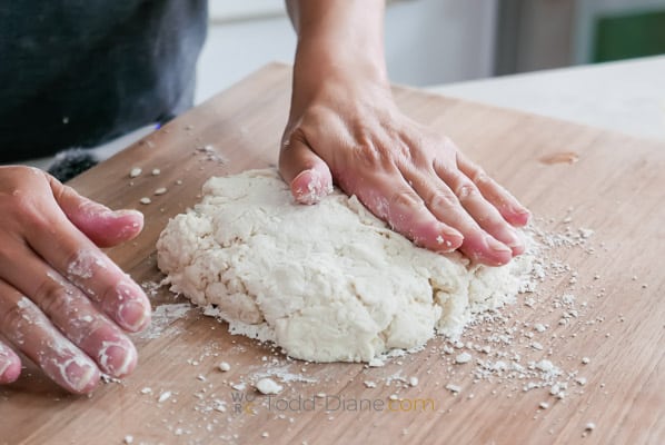 pressing down on dough