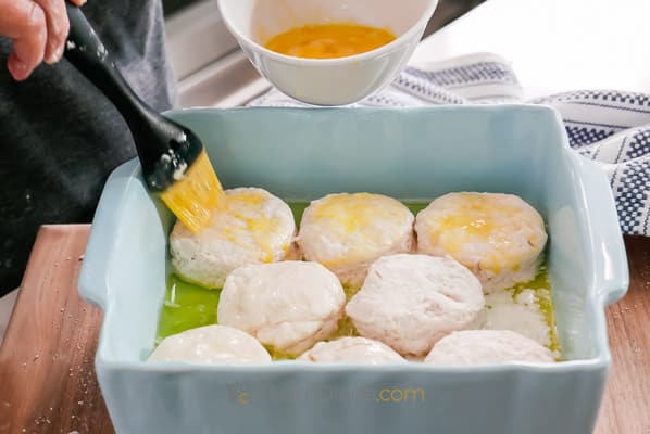 brushing biscuits with egg