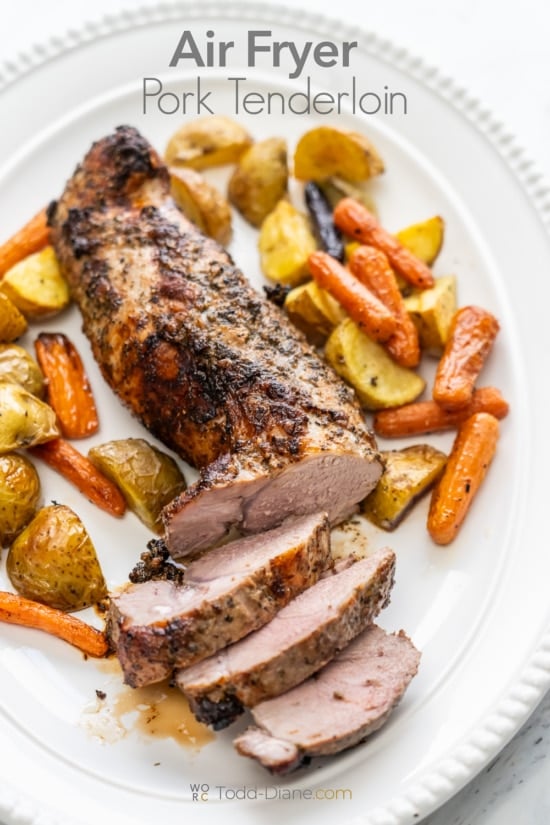 air fryer pork tenderloin on plate with veggies 