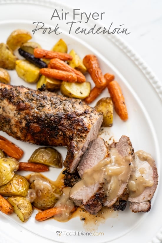 air fried pork tenderloin with gravy and veggies on platter 