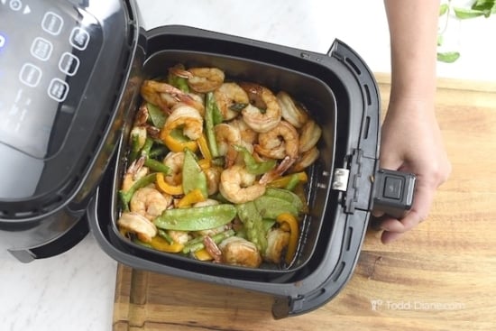 shrimp in air fryer basket ready to cook