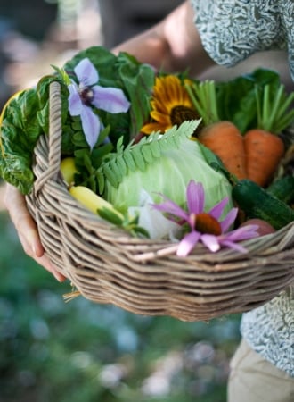 Basket of flowers and fresh picked vegetables