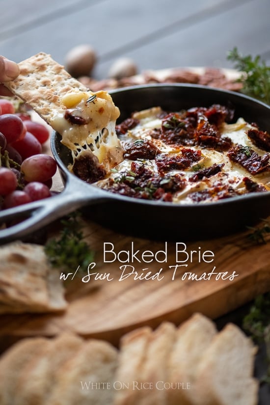 Baked Brie Dip Recipe with Garlic Sun Dried Tomato cracker dipping into dip