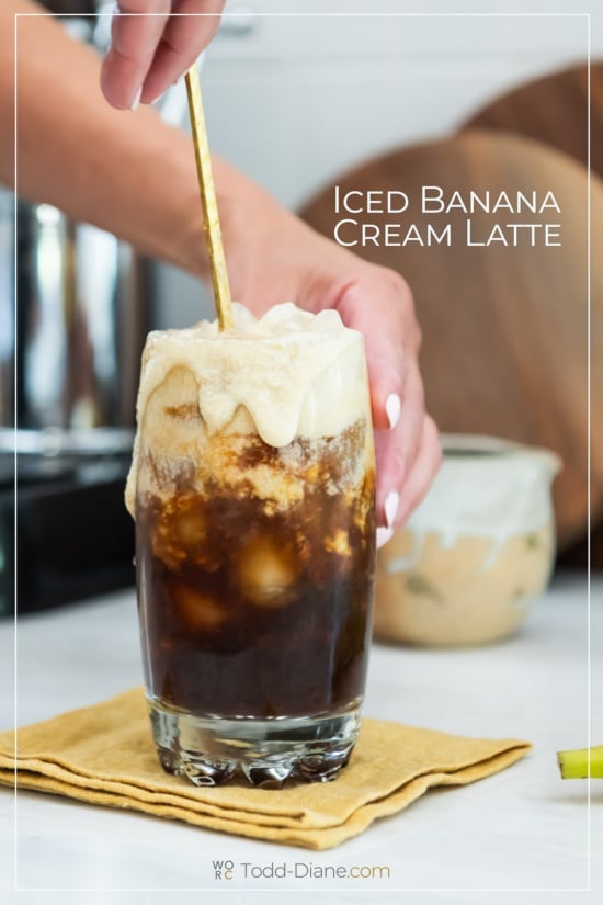 stirring iced banana cream latte with spoon 