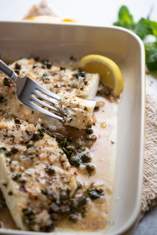 Broiled Halibut Lemon Caper Sauce on a plate with a fork