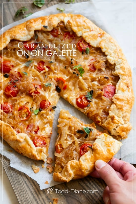 holding slice of caramelized onion galette