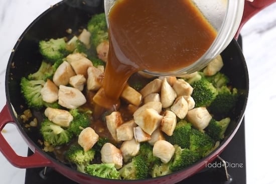 Pouring sauce into the stir fry