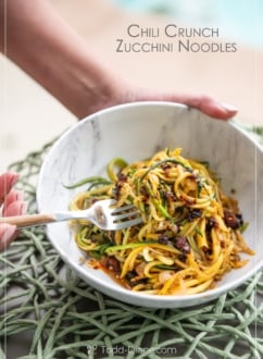 chili crunch zucchini noodles with fork holding bowl
