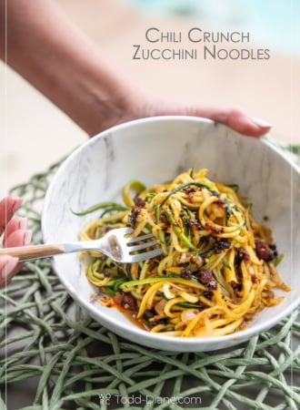 chili crunch zucchini noodles with fork holding bowl