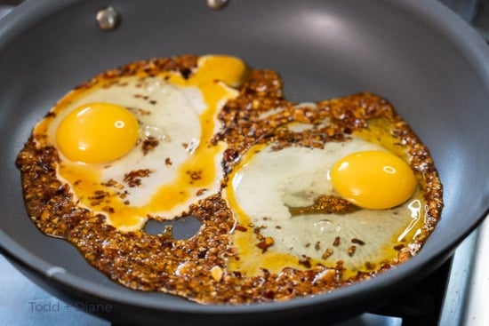 Raw egg in pan with chili crisp