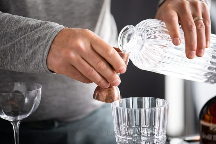 Pouring gin for a white lady cocktail from whiteonricecouple.com