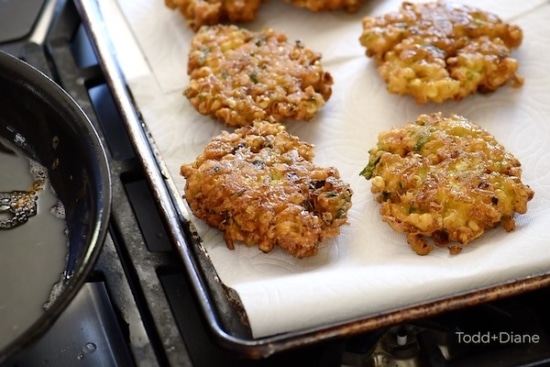Cooked corn fritters draining on paper towels