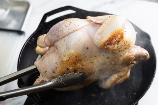 Searing the whole chicken on a pan