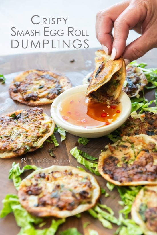 dipping crispy smash egg roll dumpling in fish sauce dip 
