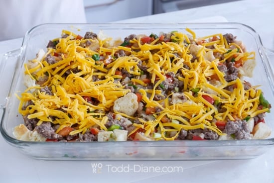 adding meat and cheese to baking dish