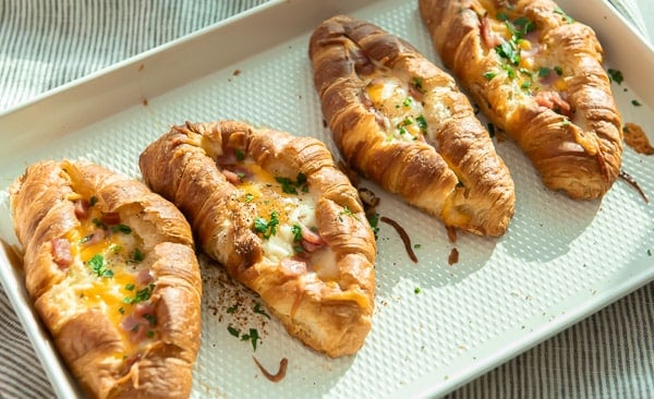 Baked croissant egg boats