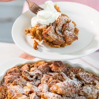 serving of croissant pumpkin bread pudding with whipped cream