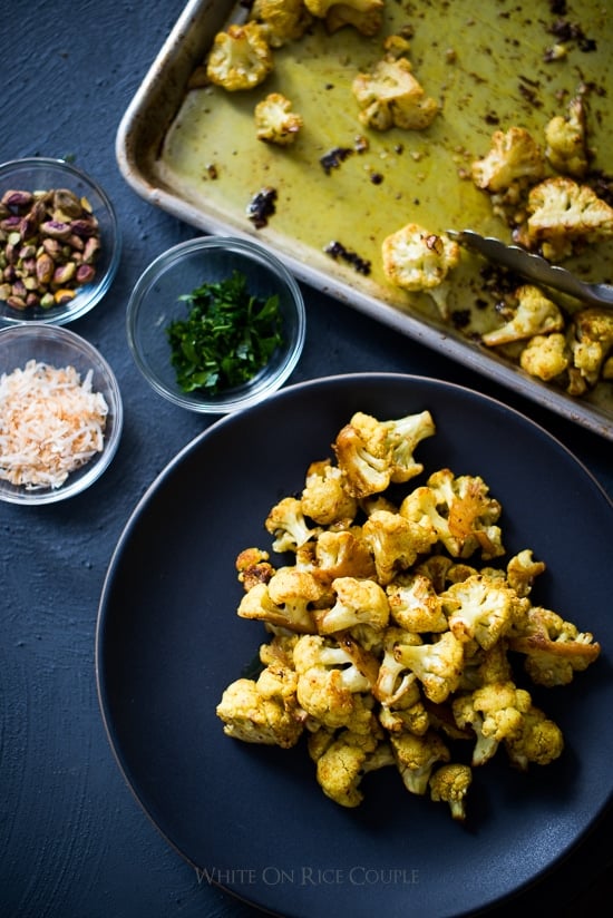 Roasted Curry Cauliflower with Turmeric, Pistachios, Coconut Flakes on a plate
