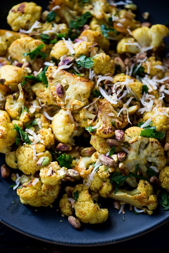Roasted Curry Cauliflower with Turmeric, Pistachios, Coconut Flakes on a plate