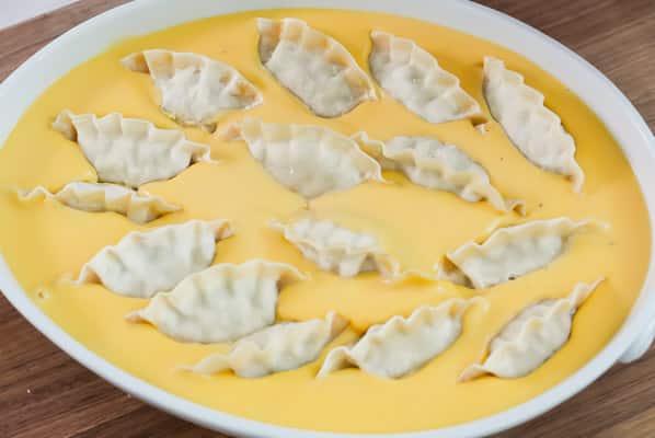 Dumplings added to sauce