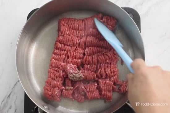 Raw beef added to a hot pan