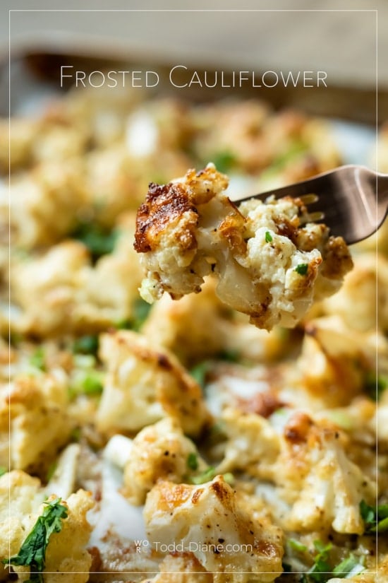 fork piercing frosted cauliflower with cheese