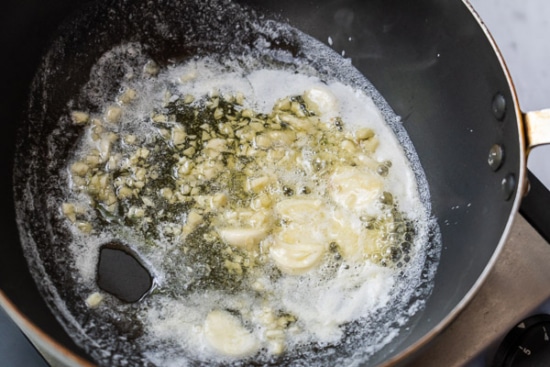 Chopped garlic cooking in butter