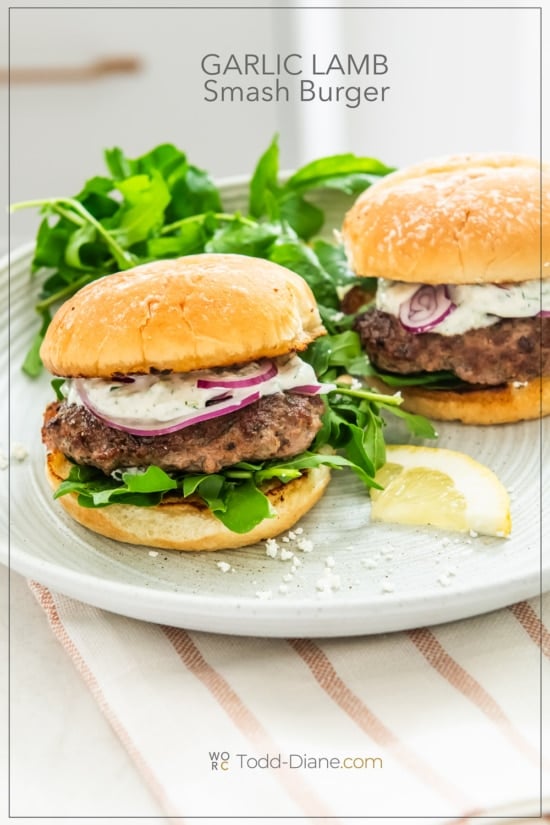 loaded garlic lamb smash burgers on plate with arugula 