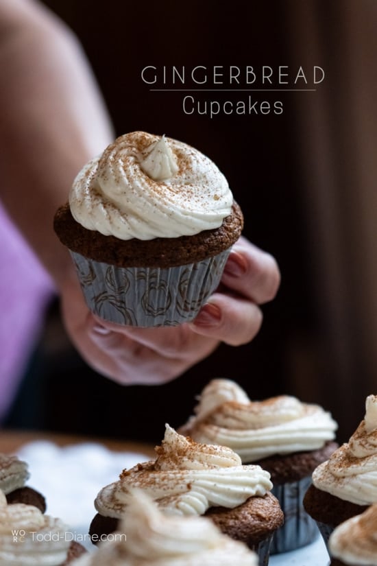 gingerbread cupcakes with maple frosting holding 