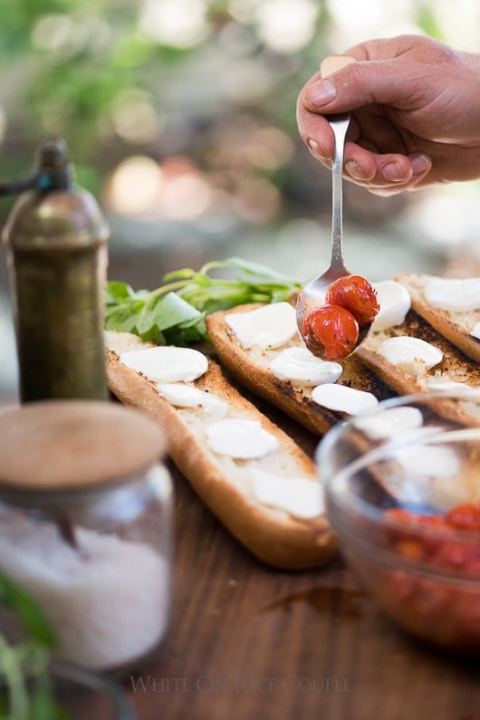 Grilled Bruschetta Recipe with Mozzarella Cheese, basil and Tomatoes on a cutting board