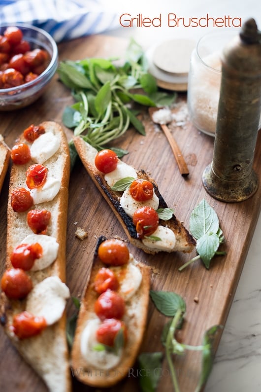 Grilled Bruschetta Recipe with Mozzarella Cheese, basil and Tomatoes on a cutting board