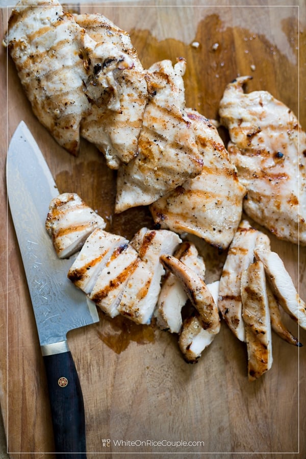 cutting board with sliced Vietnamese marinated banh mi chicken by whiteonricecouple.com