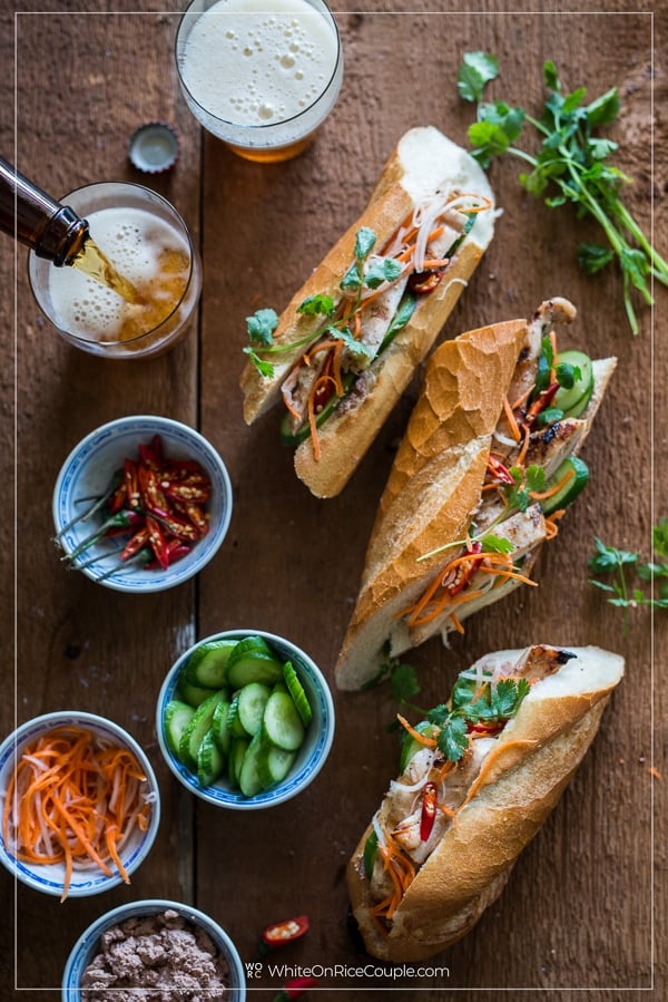 Platter of Vietnamese chicken banh mi assembly and glass of beer