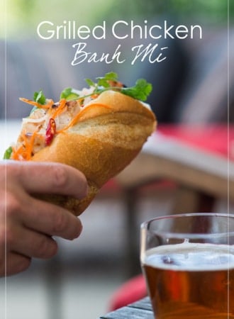 Hand holding Grilled Chicken Vietnamese Banh Mi by WhiteOnRicecouple.com