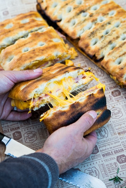 hand splitting bbq grilled cheese sandwich