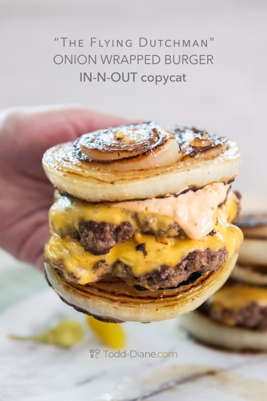 holding onion wrapped flying dutchman burger 