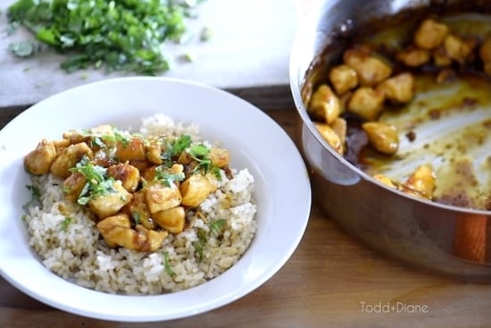 Serving orange chicken over rice