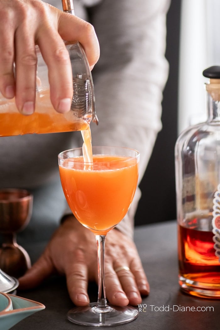 Paper Plane Cocktail Recipe with Bourbon pouring into glass