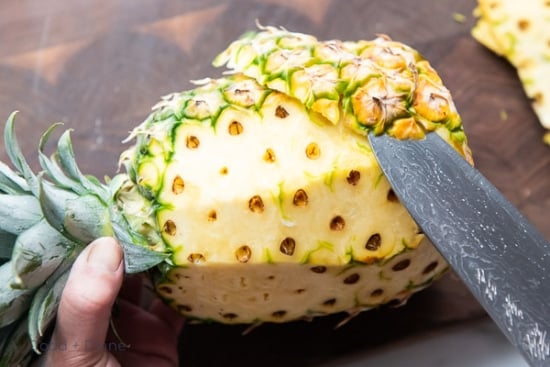 slicing peel of pineapple