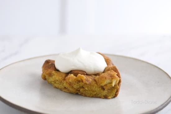 Slice of bread pudding with whipped cream on top
