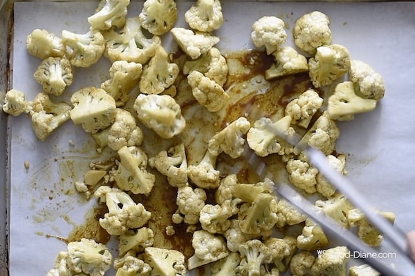 Spreading cauliflower onto sheet pan