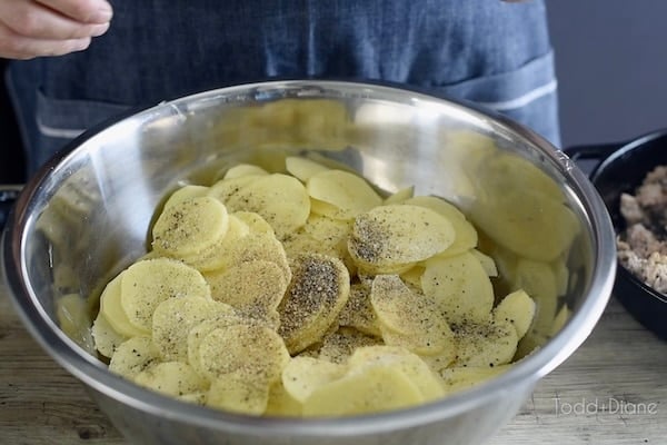 Seasoning the potato slices