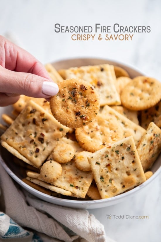 holding a seasoned ritz cracker 