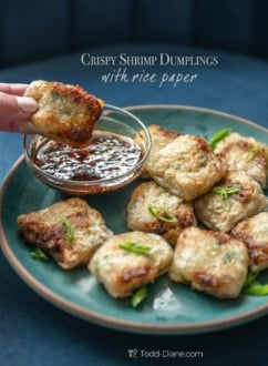 dipping crispy rice paper shrimp dumpling in sauce