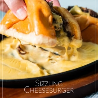 holding sizzling cheeseburger