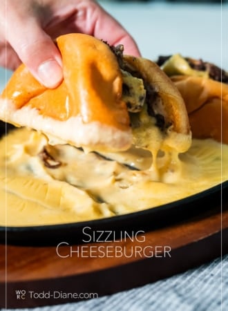 holding sizzling cheeseburger