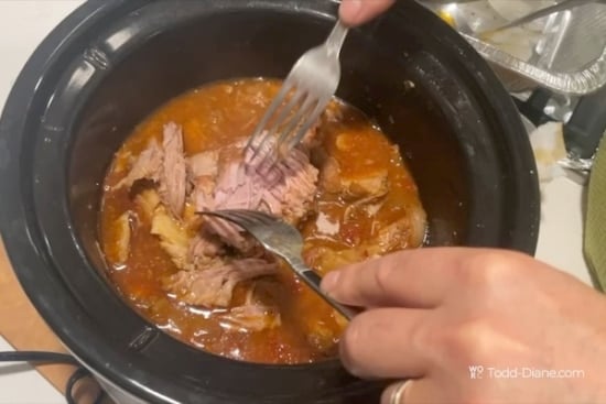 Shredding the pork with forks