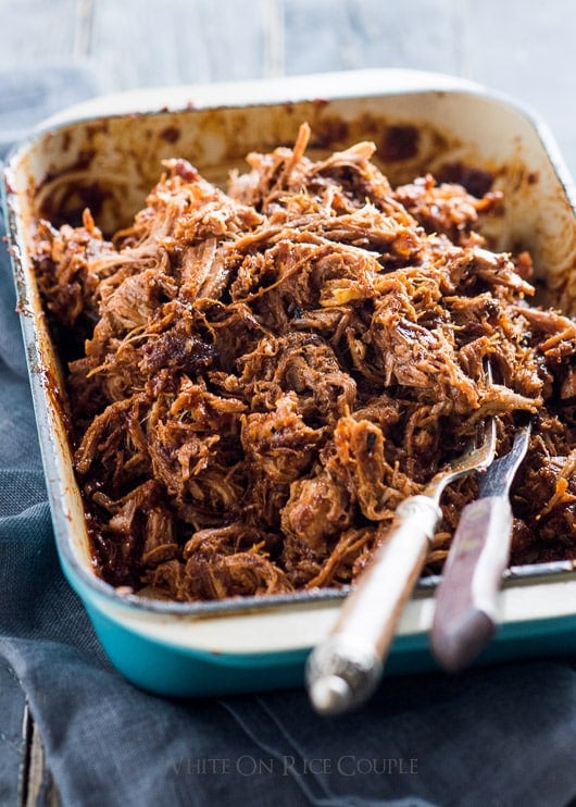 Sweet and Sriracha Spicy Oven Roast Pulled Pork in a baking dish