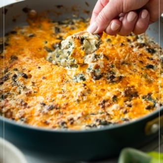 chip dipping into hot stovetop artichoke spinach dip